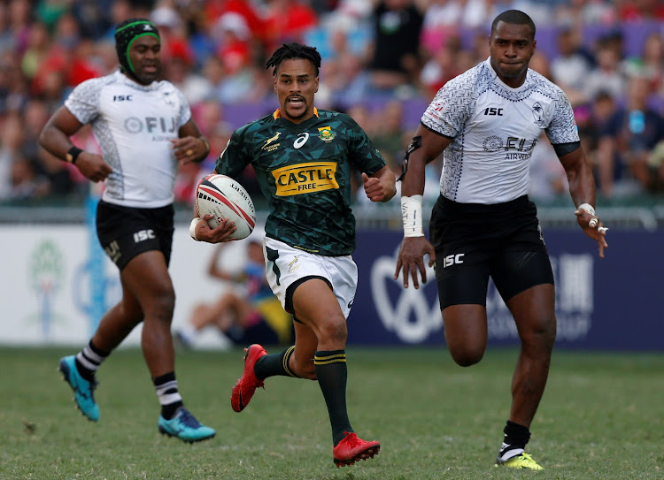 South Africa's Selvyn Davids runs to score a try against Fiji at the Hong Kong Sevens.