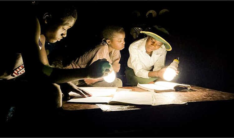A family uses solar lanterns