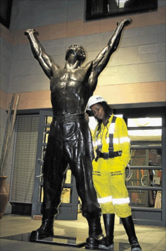 YOU GO GIRL: Third-year mining engineering student Mpeo Mahase stands next to the sculpture of the Unknown Miner at the University of the Witwatersrand. PHOTO: BAFANA MAHLANGU