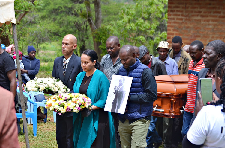 Children of the fallen former Kitui North MP, Dr. Justus Kitonga, Jeremiah Kitonga and Jessica Kaingi, lead pall bearers during the burial of the remains of the former legislator at Kyamboo Village in Mwingi west sub-county, Kitui county on Saturday.