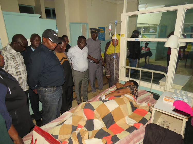 Busia governor Paul Otuoma checking one of the patients at the Busia County Referral Hospital after the accident.