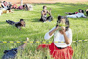 GRASS ROOTS: Members of the Rabboni Centre Ministries, under 'miracle man' pastor Lesego Daniel, eat grass as part of a ritual to show that humans can be controlled by the spirit of God