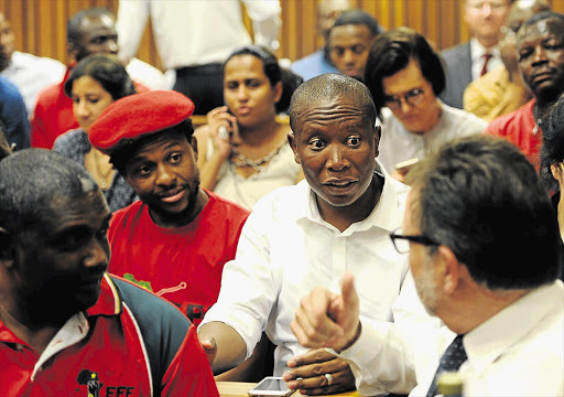 ON THE CASE: EFF leader Julius Malema talks to DA MP James Selfe in the Pretoria High Court during yesterday's hearing on the state-capture report