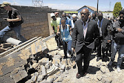 Human Settlements Minister Tokyo Sexwale inspects the site in Lenasia Extension 13 where houses were demolished. File photo.