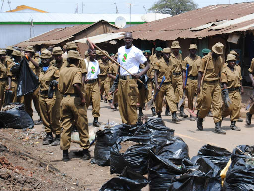 NYS Men and Women participate in the slum cleanup exercise after it was launched in Kibera. /FILE