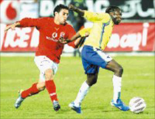 CHASE: Al Ahly's Anis Boujelbene tugs at Mamelodi Sundowns' Godfrey Sapula in the Champions League clash in Cairo. Pic. Chris Ricco. 20/04/2007. © Backpagepix.