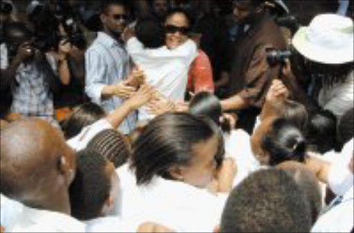 LOVED: Laila Ali gets a hug from a pupil at Thabo High school in Naledi on her tour of Soweto earlier this week. Pic. Tsheko Kabasia. © Sunday World.