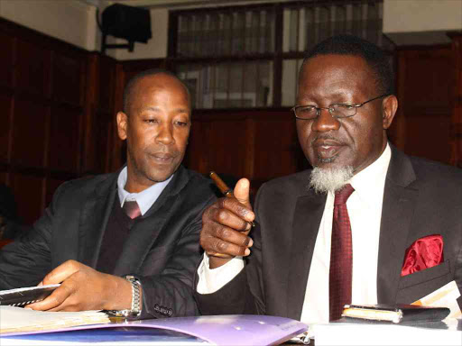 Kapseret MP Oscar Sudi lawyer Thomas Ruto (right) at the Milimani law court yesterday /COLLINS KWEYU