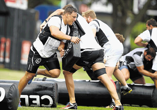 OOF! Coenie Oosthuizen tackles Ruan Botha during the Sharks' training session this week.