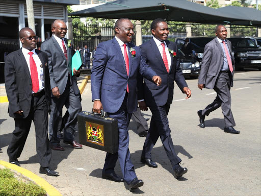 Treasury Cabinet Secretary Henry Rotich and Devolution CS Mwangi Kiunjuri arrive at Parliament Buildings for the presentation of 2016-17 budget on June 8 /HEZRON NJOROGE