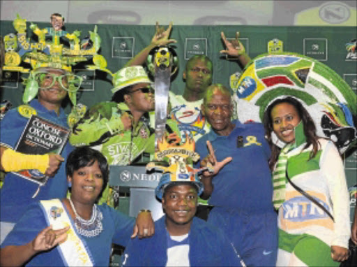 KE YONA : Soccer fans pose with the trophy during the Nedbank Cup last-eight draw at The Venue in Melrose Arch, in Johannesburg, yesterday. Photo: Gallo Images