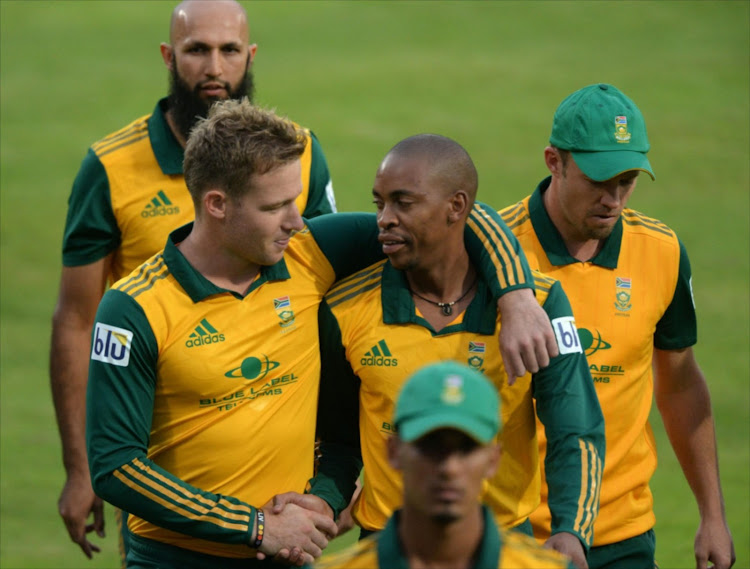 David Miller and Aaron Phangiso during the 3rd KFC T20 International match between South Africa and Australia at SuperSport Park on March 14, 2014 in Centurion, South Africa.