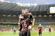 Germany's Toni Kroos celebrates with teammates Miroslav Klose and Sami Khedira after scoring a goal during the World Cup semifinal between Brazil and Germany at the Estadio Mineirao.