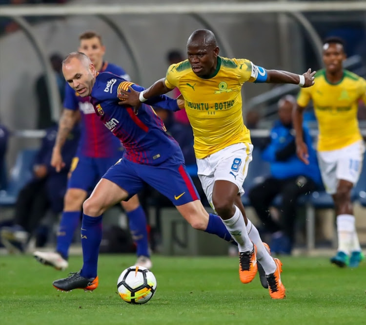 Hlompho Kekana (c) of Mamelodi Sundowns shields the ball from A. Iniesta (c) of Barcelona during the International Club Friendly match between Mamelodi Sundowns and Barcelona FC at FNB Stadium on May 16, 2018 in Johannesburg, South Africa.