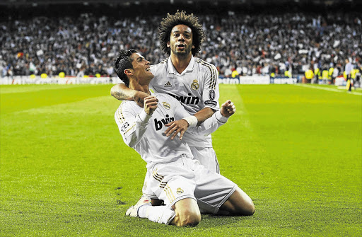 Real Madrid's Cristiano Ronaldo is congratulated by Marcelo after scoring a penalty against Bayern Munich in the first half of their Champions League semifinal second leg the Bernabeu stadium in Madrid last night. Ronaldo scored another during regular time but had his shot saved during the penalty shoot-out as Bayern went on to win 3-1 on penalties after the match ended 2-1 on the night and 3-3 on aggregate