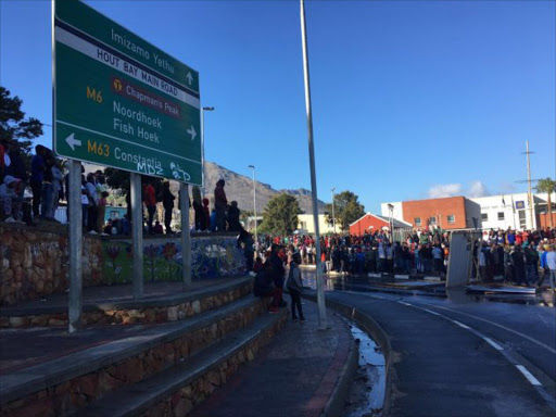 Protesters mass at the traffic circle at the entrance to Hout Bay this morning. Picture Esa Alexander.