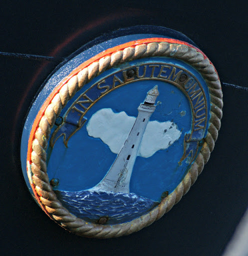 Pole Star Link is a buoy tender, operated by the Northern Lighthouse Board. The plaque is on the bow and was photographed at Customhouse Quay, Greenock. "In Salutem Omnium" means "For the Safety...