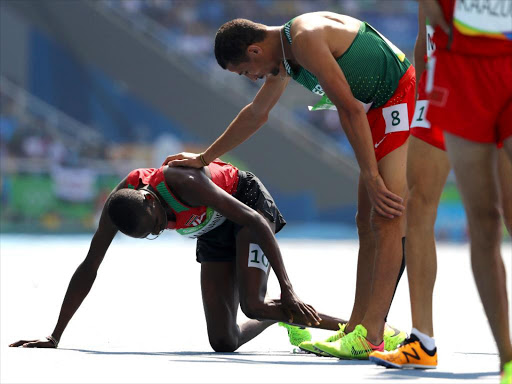 Kenya's Elijah Manangoi is helped by Algeria's Taoufik Makhloufi after finishing round 1 of the 1,500m race at the Olympic Stadium in Rio de Janeiro, August 16, 2016 /REUTERS