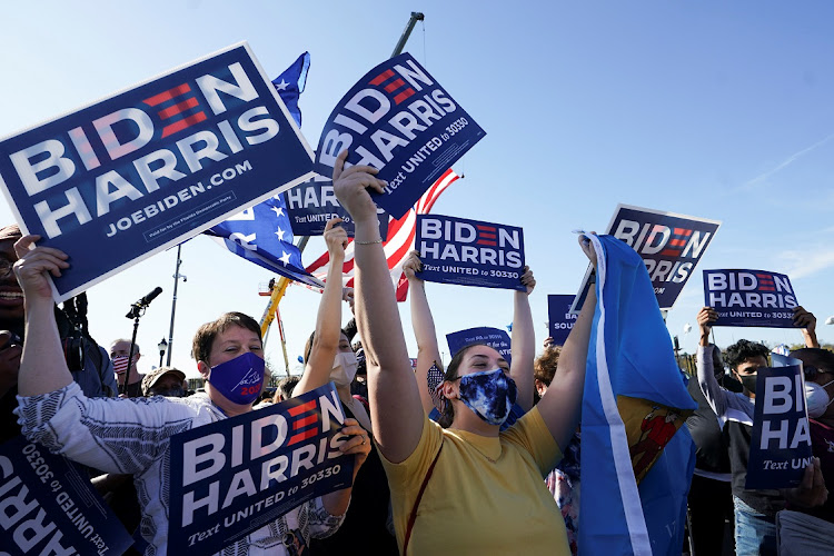 Supporters of Democratic US presidential nominee Joe Biden celebrate near the site of his planned election victory celebration after news media declared Biden to be the winner of the 2020 US presidential election in Wilmington, Delaware, US, November 7, 2020.