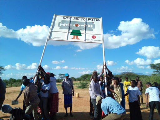 Villagers living within Westgate conservancy in Samburu East erecting a billboard to warn against FGM. /MARTIN FUNDI