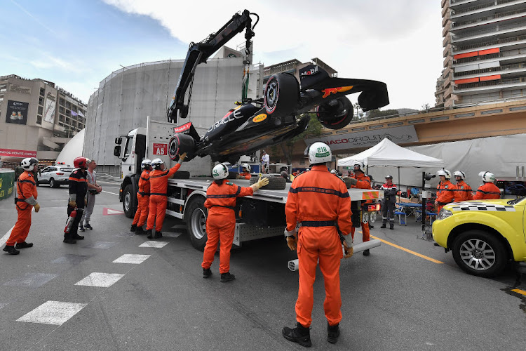 Perez's car was craned off the street circuit after the qualifying incident, with the rarely seen floor of the Formula One car easily photographed.