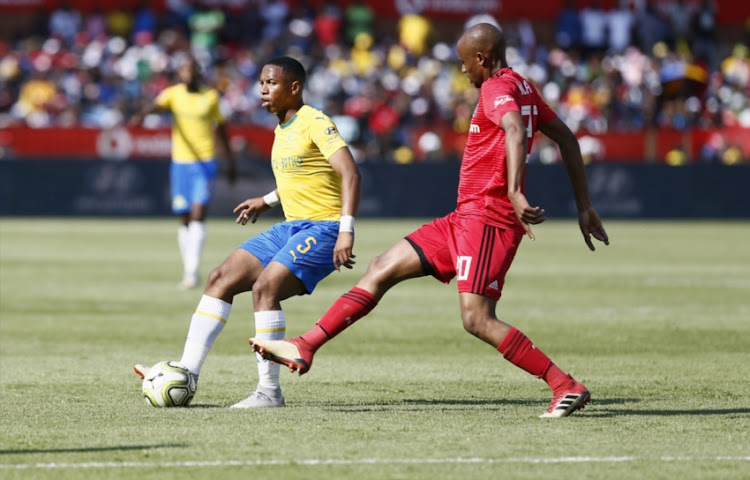 Andile Jali of Mamelodi Sundowns is tackled by Xola Mlambo of Orlando Pirates during the Absa Premiership match between Mamelodi Sundowns and Orlando Pirates at Loftus Versfeld on November 10, 2018 in Pretoria, South Africa.