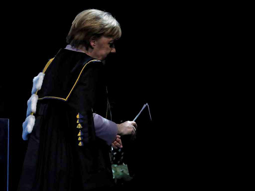 German Chancellor Angela Merkel leaves the stage after receiving a degree Honoris Causa, or honorary doctorate, from Belgian universities of KU Leuven and UGent, in Brussels, Belgium January 12, 2017. REUTERS/Yves Herman