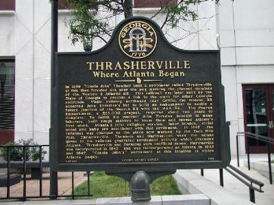 In 1839 "Cousin John" Thrasher built a settlement called Thrasherville at this then forested site near the peg marking the planned terminus of the Western & Atlantic RR. This railroad was later...