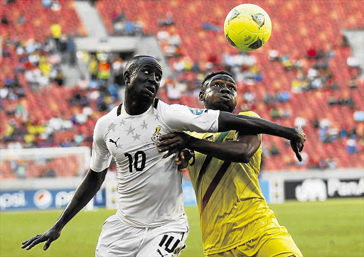 Ghana's Albert Adomah (left) and Mali's Adama Tamboura fight for the ball during their Africa Cup of Nations Group B game at the Nelson Mandela Bay Stadium yesterday. Ghana won 1-0 to improve their chances of qualifying for the knockout stages