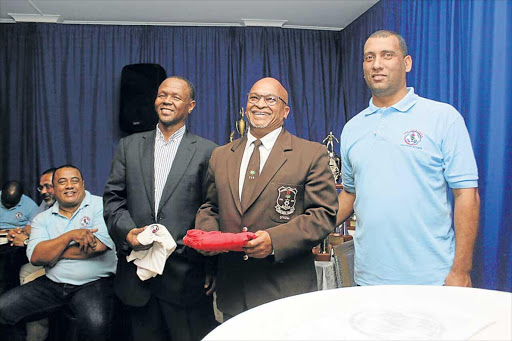 MUCH TO SMILE ABOUT: Complimentary EL Central shirts were handed over to Mdantsane LFA (Mdalfa) deputy president Xolani Bishoti, left, and Ernest Frazer after their inspirational speeches delivered at the EL Central prize-giving awards evening