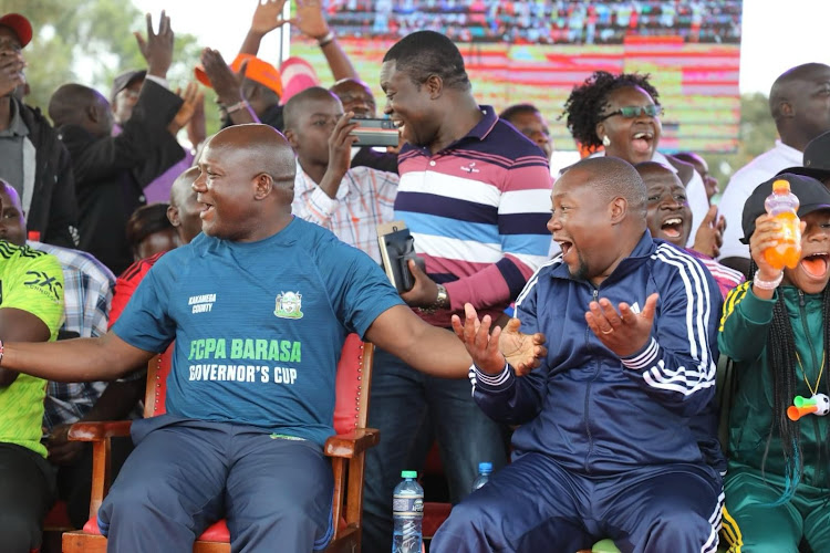 Kakamega Governor Fernandes Barasa, Likuyani MP Innocent Mugabe celebrate during a football match in Likuyani constituency