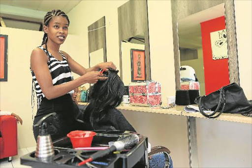 HELPING HANDS: Vuyelwa Longa of Lovey Dovey Hair Salon, above, and Sibongile Xolo, below, of Next Level clothing are inviting matric pupils from rural and township schools to come and pick an outfit, get their hair and make-up done for their matric dance up at their studio in Vincent Park Pictures: STEPHANIE LLOYD