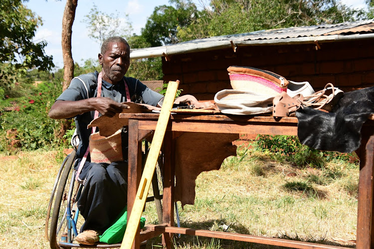 Leather craftsman Matei Mutuku cuts pieces of leather at the Danida workshop in Mwatate, Taita Taveta county. He is one of the mentors at the group