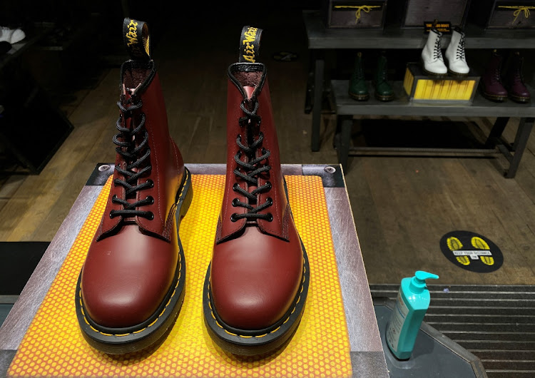 A pair of Dr. Martens boots seen through the window of a Dr Martens shop in London, Britain. Picture: SIMON NEWMAN/REUTERS