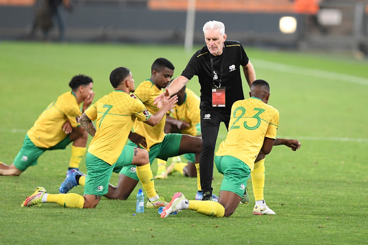Bafana Bafana coach Hugo Broos interacts with players as they do stretching exercises. The team may find themselves playing against top-ranked European teams this year. Picture: LEFTY SHIVAMBU