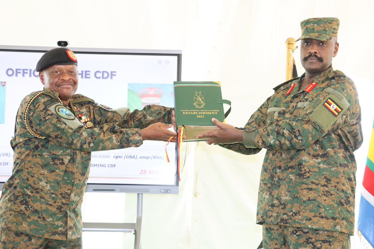 Gen Muhoozi recieves instruments from Outgoing Gen Wilson Mbadi now appointed State Minister for Trade.