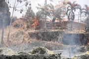Volcanic gases rise from a fissure in the Leilani Estates subdivision during ongoing eruptions of the Kilauea Volcano in Hawaii, US, May 14, 2018. 