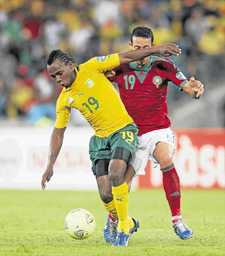 MY BALL: May Mahlangu of South Africa and Kamal Chafni of Morocco battle for possession during a 2013 African Cup of Nations match at Moses Mabhida Stadium in Durban Picture: GALLO