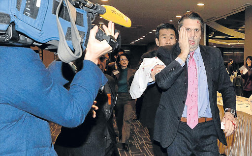 SHOCK ATTACK: US ambassador to South Korea Mark Lippert was attacked by a yelling knifeman at a breakfast forum to discuss Korean reunification yesterday in Seoul, South Korea Picture: GETTY IMAGES