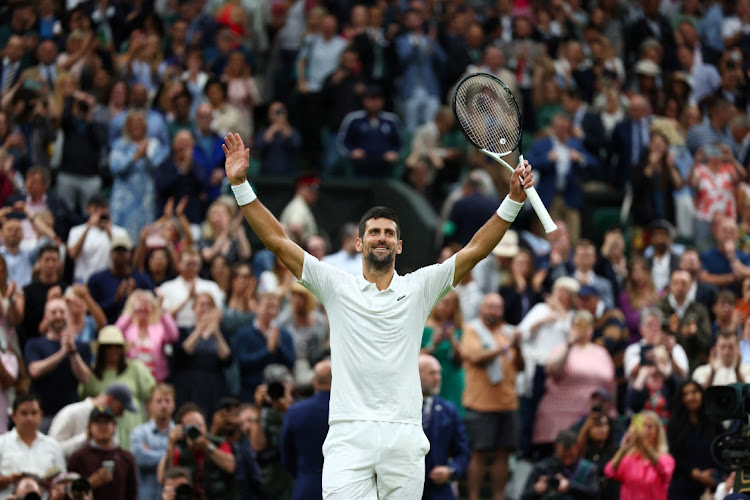 Serbia's Novak Djokovic celebrates winning his Wimbledon semifinal against Italy's Jannik Sinner at the All England Lawn Tennis and Croquet Club in London on July 14 2023.