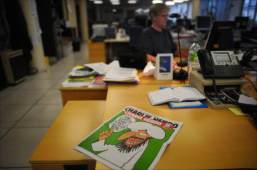 A picture taken on 1 November 1 2011 in Paris shows the cover of an issue of Satirical French magazine Charlie Hebdo featuring prophet Mohammed. File photo.