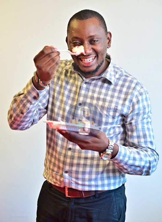 Senior Account Manager Njoga Kimani showing off a piece of cake at Radio Africa Group, Lions Place.