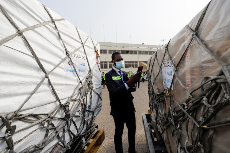 A worker checks boxes of AstraZeneca/Oxford vaccines as Ghana receives its first batch of coronavirus disease vaccines under COVAX scheme, at the international airport of Accra, Ghana on February 24, 2021.