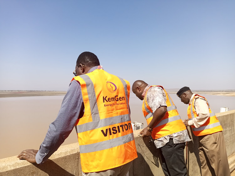 Energy and Petroleum CS Davis Chirchir and the PS Alex Wachira inspect the water levels at Masinga dam on February 10, 2023.