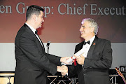 CLEAR LEADER: Aspen Pharmacare group CEO Stephen Saad receives the Business Leader award from former Sunday Times editor Ray Hartley at the 2012 Top Companies banquet. File photo