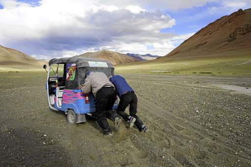 Pushing a tuk tuk in the Himalayas for the Rickshaw Run, a 3,000km rickshaw race across India.
