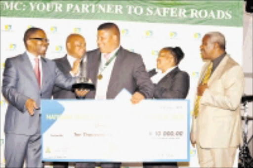 LUCKY MAN: Minister of Transport Sbu Ndebele, Premier Cassel Mathale, MEC for roads and transport Pinky Kekana and Ranthoko Rakgoale, chief executive officer of the Road Traffic Management Corporation, hand over a cheque, trophy, medal and certificate to National Driver of the Year competition winner Jonathan Bexter from Eastern Cape, on Friday night. Pic: ELIJAR MUSYHIANA. 26/10/2009. © Sowetan.