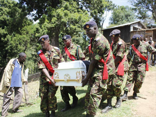 KDF soldiers lift to the grave yard the coffin containing the body of their own Wilson Kiprop Kurui, 29 who was buried at his Kasetan home in Sacho division, Baringo County on Feb 02 2016. He was among the several KDF soldiers killed by Al-Shabaab militia in El-Adde in Somalia. PHOTO/JOSEPH KANGOGO