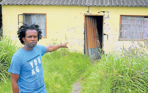 GHASTLY DISCOVERY: Mdantsane’s NU2 dog owner Njongo Mgayi in front of a house where his dog was killed, skinned, cooked and eaten by his neighbour Picture: ASANDA NINI