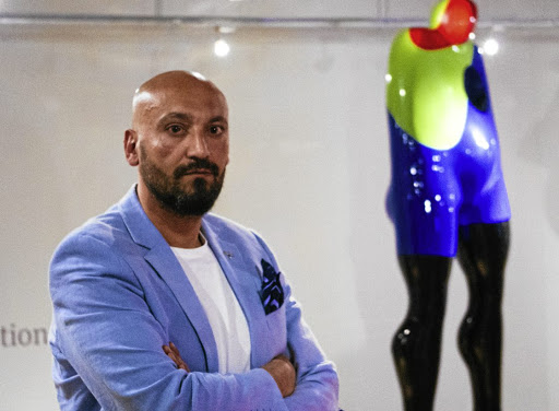 Slick finish: Sam Shendi poses at Graham’s Fine Art Gallery alongside a work from his Giant collection. These large imposing resin sculptures represent different stages of depression the artist went through after abuse